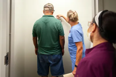 A patient gets weighed at a medical clinic provided free of charge to local residents in Hope, Ark. on Sept. 7, 2023. Photo by Rory Doyle.